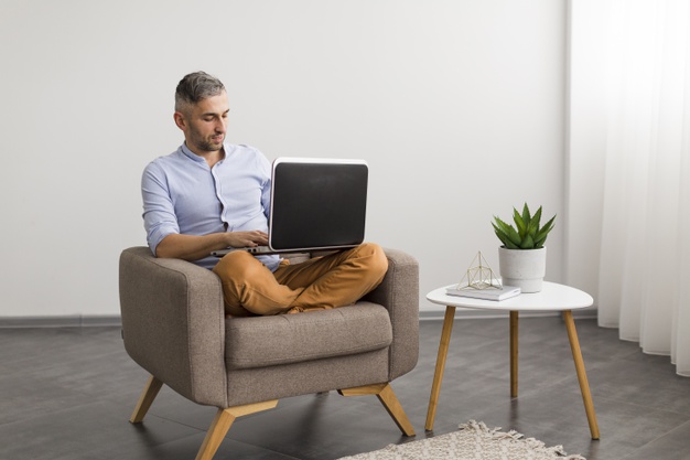 long-view-man-using-his-laptop-indoors_23-2148401423